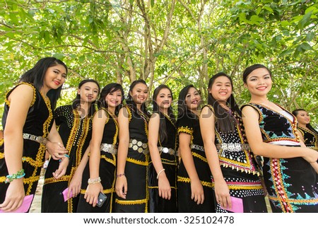 Kota Kinabalu, Malaysia - May 30, 2015: Girls of various Dusun ethnic in their traditional costume pose for the camera during the Sabah State Harvest festival celeberation in tambunan, Sabah.