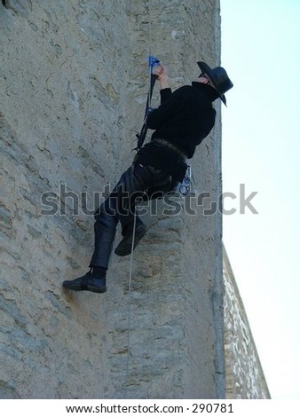 man climbing up the wall