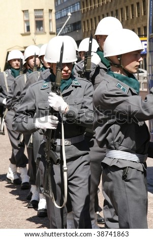 HELSINKI, FINLAND - 1ST JUNE: A small military parade interrupted business at the market as vendors and buyers alike ran to the street to watch the parade on 1st June, 2007 in Helsinki, Finland.