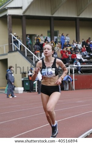 TARTU, ESTONIA - MAY 20: Athlete running along the track and taking part in Student Sell Games, organized by Estonian Academic Sports Federation in May 20, 2006. The event was held in Tartu, Estonia.