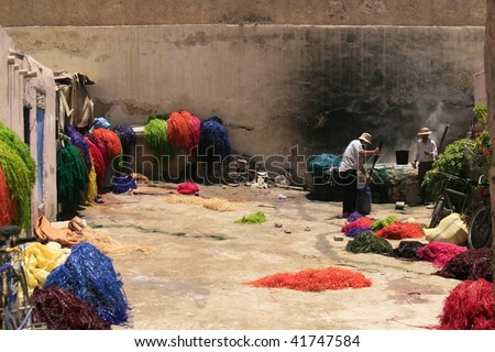 FES, MOROCCO - JUNE 9: Men coloring dried hay with bright dye on June 9, 2008 in Fes, Morocco. The dye used is very poisonous and often creates health issues for workers