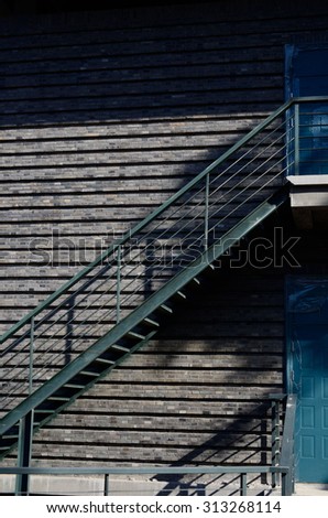 steel stairs near a door in navy blue