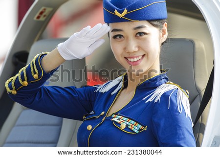 ZHUHAI, CHINA - NOV. 11. 2014:Flight attendant poasing in airplane on Airshow China 2014 in Zhuhai, Guangdong province.