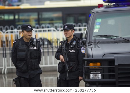 GUANGZHOU, CHINA - MARCH 6. 2015:Armed paramilitary policemen stand guard in front of the Guangzhou Railway Station after a knife attack, in Guangzhou, Guangdong province.