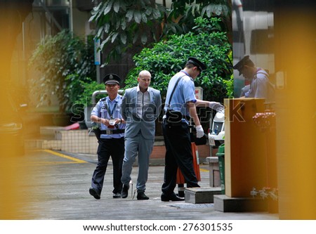 GUANGZHOU, CHINA - MAY 7. 2015:Police escort Peter Gardner as he enters court in Guangzhou. An Australian man faced a possible death sentence on charges of attempting to smuggle drugs out of China.