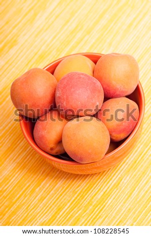 Mellow apricots in a bowl in vertical format