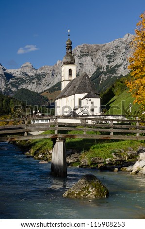 Church with mountains of the Reiteralpe in Ramsau in vertical format