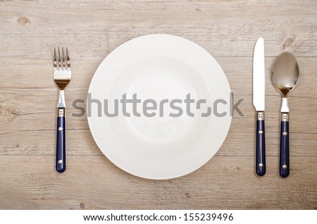Cover with knife, fork and spoon on a dining table in a restaurant