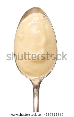 Silver spoon with soup of parsnips in vertical format