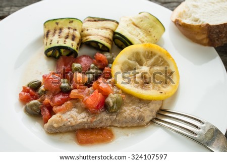 Veal cutlet with tomatoes, capers and lemon sauce