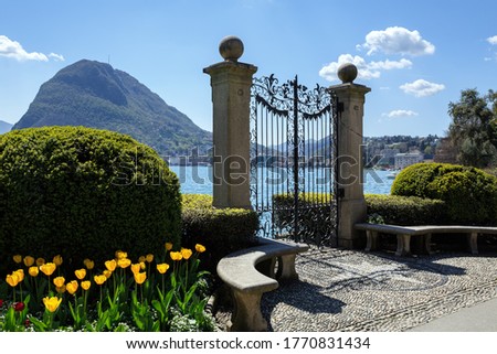 Old gate in Park Ciani at the lake Lugano on a sunny spring day. View of the San Salvatore mountain. Town of Lugano, canton of Ticino, Switzerland, Europe. Zdjęcia stock © 