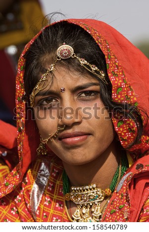 PUSHKAR, INDIA - NOVEMBER 21: An unidentified girl attends the Pushkar fair on November 21, 2012 in Pushkar, Rajasthan, India. Pilgrims and camel traders flock to the holy town for the annual fair.