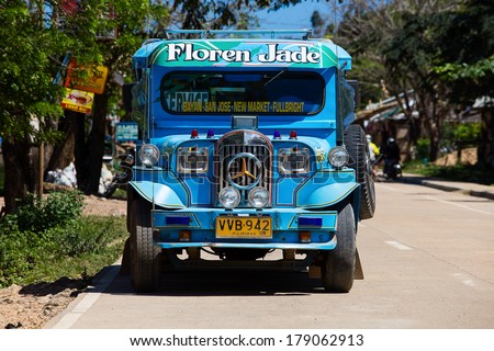 EL NIDO, PHILIPPINES - JANUARY 29, 2014 :Jeepneys passing, Philippines inexpensive bus service. Jeepneys are the most popular means of public transportation in the Philippines.