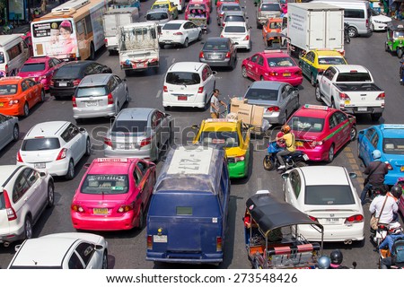 BANGKOK, THAILAND - JANUARY 22, 2015: Traffic moves slowly along a busy road in Bangkok, Thailand. Annually an estimated 150,000 new cars join the already heavily congested streets of Bangkok.