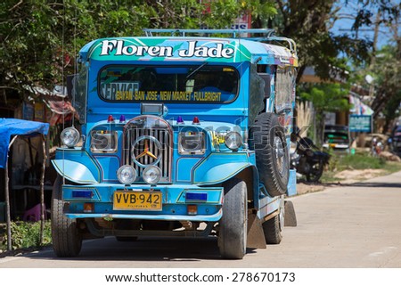 EL NIDO, PHILIPPINES - JANUARY 29, 2014: Jeepneys passing, Philippines inexpensive bus service. Jeepneys are the most popular means of public transportation in the Philippines.
