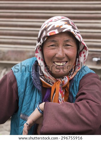 LEH, INDIA - JUNE 21, 2015: Unknown beggar woman begging on the street in Leh, Ladakh. Poverty is a major issue in India