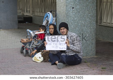 ISTANBUL, TURKEY - AUGUST 03, 2015 : Unknown refugees from Syria are asking for help on the street in Istanbul