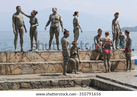 DALYAN, TURKEY - AUGUST 20, 2015 : Unidentified people are taking a mud bath. Mud baths are great for the skin.