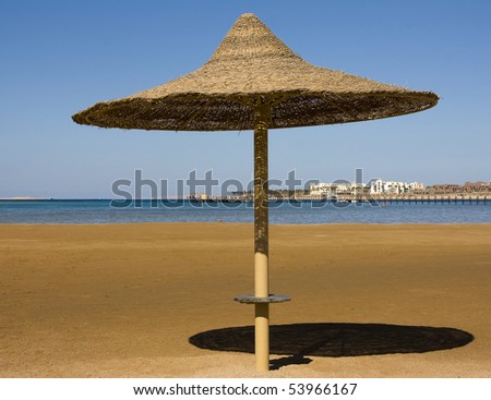 Beach umbrella on the shore of the Red Sea. Hurghada city in Egypt.