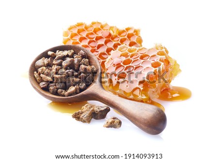Honeycombs with propolis granules on white background