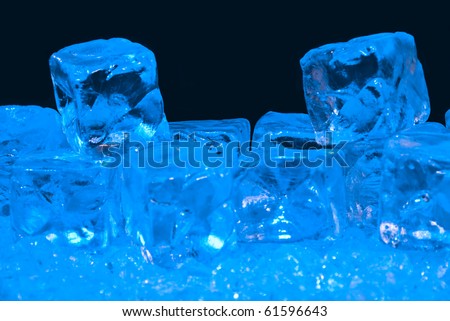 Blue Tinted Ice Cubes on Blue CRushed Ice with a Black Background