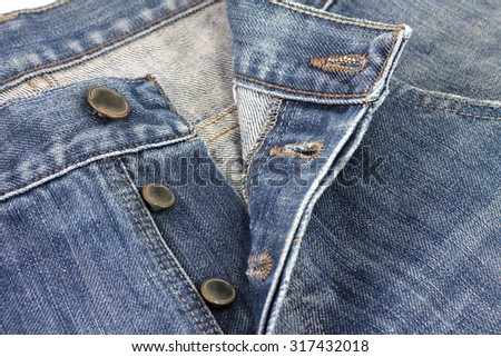 close up metal button on jeans