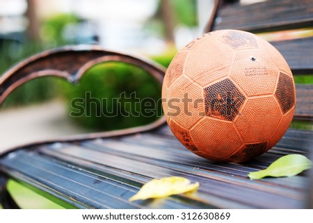 Old football ball on chair