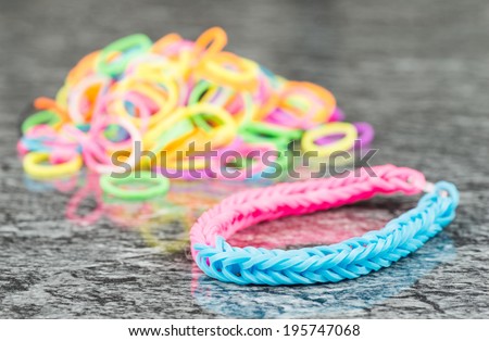 Rubber band bracelet on reflective background