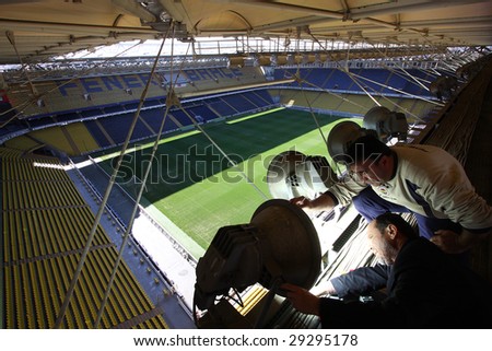 ISTANBUL – CIRCA APRIL 2009 : Stadium workers fix lighting system at Fenerbahce Sukru Saracoglu Stadium for 2009 UEFA Cup Final circa April 2009 in Istanbul, Turkey.