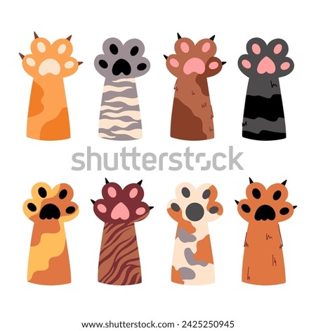 A collection of colored paws of a cat. Various cartoon paws. Funny furry paws, sharp claws