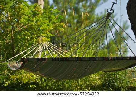Abstract close up perspective of a hammock in the shade in the summer time.