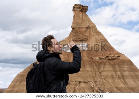 Similar – Image, Stock Photo Male traveler in Bardenas Reales in summer