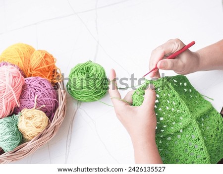 Similar – Image, Stock Photo Close-up of a knitted piece with wooden knitting needles and ball of wool