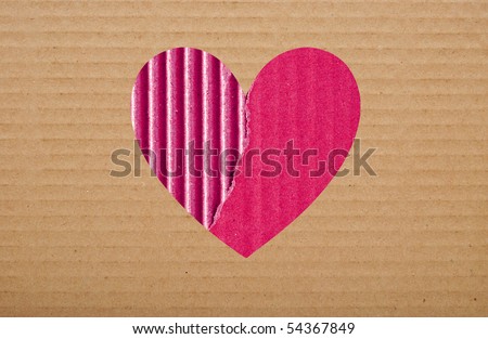 pink paper hole in brown cardboard background