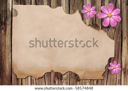 edged burned paper over panel wood background