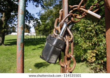 Rusty school gate chained and padlocked