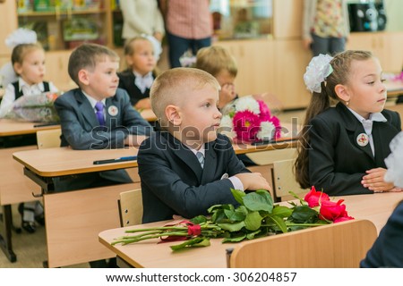 NOVOKUZNETSK, KEMEROVO REGION, RUSSIA - SEPTEMBER, 1, 2014: First-grade students and teacher are in school classroom at first lesson. The day of knowledge in Russia.