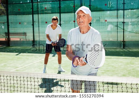 Similar – Image, Stock Photo senior man playing paddle tennis at indoors pitch, he is tired