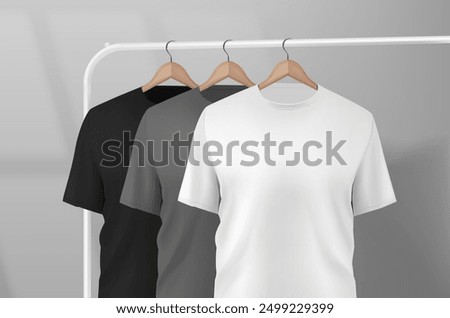 Basic black male t-shirt realistic mockup hanging on a clothes rack in a studio on a wooden hanger. t-shirt sleeve design for mockup.