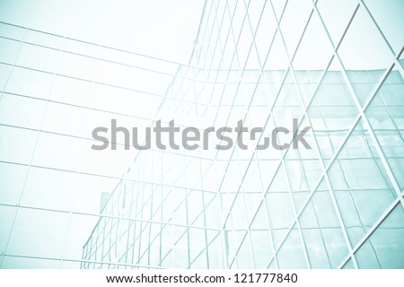 Panoramic and perspective wide angle view to steel blue background of glass high rise building skyscrapers in modern futuristic downtown at night