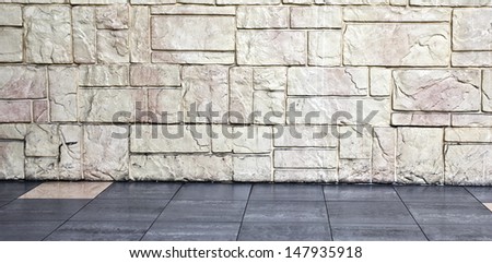 Grungy textured red and yellow stone wall inside old neglected and deserted interior, masonry and carpentry brickwork concept