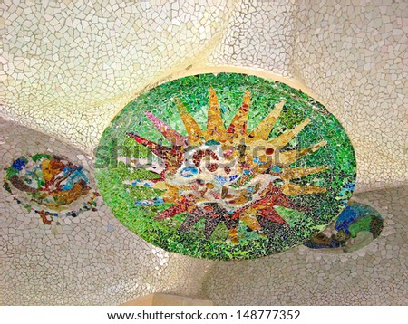 BARCELONA, SPAIN - JULY 19: Ceramic mosaic Park Guell on July 19, 2013 in Barcelona, Spain. Park Guell is the famous architectural town art designed by Antoni Gaudi and built in the years 1900 to 1914
