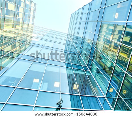 Panoramic and perspective wide angle view to steel blue background of glass high rise building skyscrapers in modern futuristic downtown over sky Business concept of successful industrial architecture