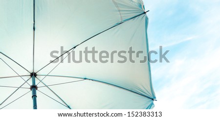 Abstract background of umbrella texture and clear sky with sparse clouds