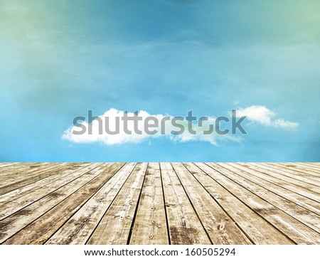 Perspective View to Fresh abstract autumn sparse clouds in the blue sky and background of wood floor texture in the evening park