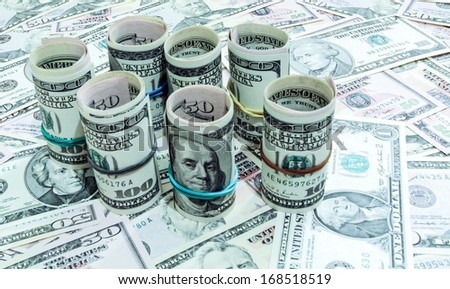 Dollars seamless background. High resolution wallpaper texture of rolled in a tube one hundred and flat fifty banknotes
