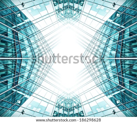 Panoramic and prospective wide angle view to steel light blue background of glass high rise building skyscraper commercial modern city of future. Business concept of successful industrial architecture