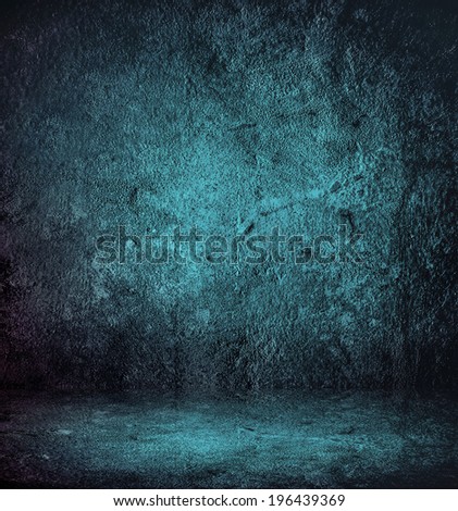 Abstract stonework background texture with old weathered dark stucco black paint stone cement wall in rural room. Grungy cold rock surface in hard grime empty place with blue granite dull light floor.