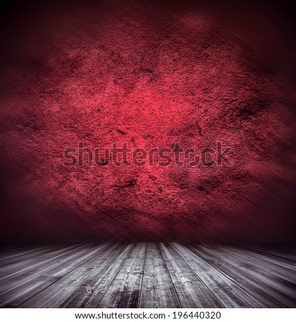 Abstract stonework background texture with old weathered dark stucco red paint stone cement wall in rural room. Grungy warm rock surface in cherry grime empty place with wood panel light brown floor.