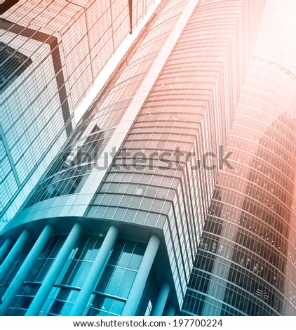 Panoramic and perspective wide angle view to steel light red background of glass high rise building skyscraper commercial modern city of future. Business concept of successful industrial architecture.
